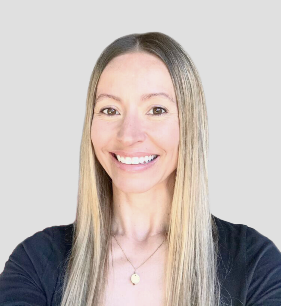 A color image of Christina Hopewell-Albert, Ed.D., Vice President of Program Impact, smiling and looking at the camera with a blurred outdoor background.
